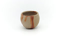 Small Bizen-yaki yunomi teacup, front view, pale clay with orange-red hidasuki fire-cord markings.