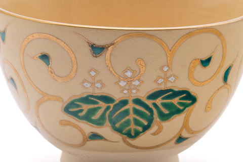 Close-up of a green paulownia leaf motif on the bowl's surface.