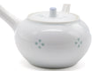 Side view of the porcelain kyusu emphasizing the spout and side handle.