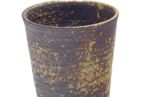 Angled overhead view showing the interior and the ribbed, ash-speckled exterior.