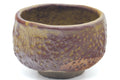 Larger front view of the brown teacup showing the rim and mottled glaze.