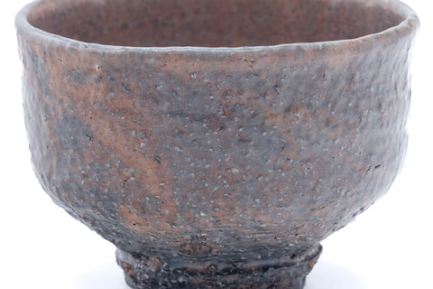 Three-quarter view emphasising the grey-and-orange hues beneath the milky glaze.