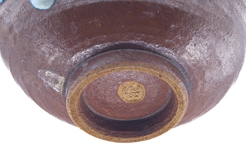 Overhead view of the underside showing the foot ring and a maker's mark.