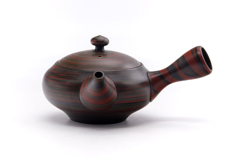 Front view of the teapot showing the spout, domed lid, and rounded body.