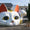 Maneki-neko — a large white beckoning-cat sculpture with red ears displayed outdoors