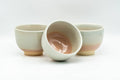 Japanese Teacups - Set of 3 Beige Pink Hagi-yaki Yunomi - 110ml - one cup tilted showing the interior among the set