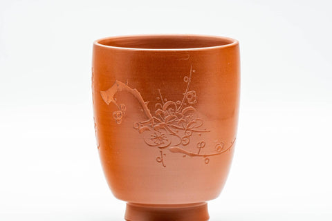 Japanese Teacups - Pair of Smooth Red Shudei Tokoname-yaki Meoto Yunomi with Wooden Box - closeup of a single cup showing the floral engraving