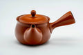 Round red shudei Tokoname-yaki side-handle kyusu, lid on, shown from the side.