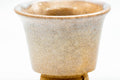 Close-up of a single guinomi showing the crackled beige glaze
