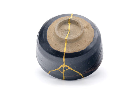 Underside of the chawan showing the foot ring and gold repair extending onto the base.