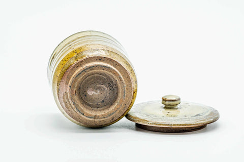 The teacup with its lid set beside it, showing the foot.