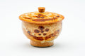 Three-quarter view of the covered yunomi with its knobbed lid in place.