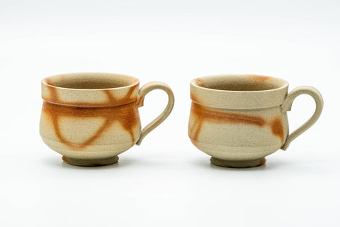 The two handled teacups side by side without saucers, front view, showing the C-shaped handles.