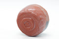 Underside view of the raku bowl showing the low foot and reddish raku clay base.