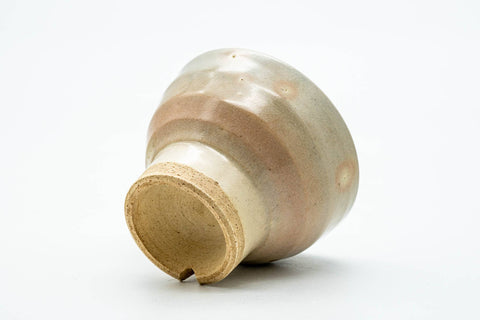 Inverted view showing the tall unglazed foot and base of the teacup.