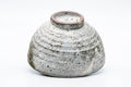 The bowl tipped to reveal its ridged foot and base.