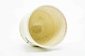 Teacup tilted to show the cream-glazed interior.