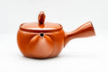 Front view with the lid on, pig figurine knob and an incised kanji character on the body.