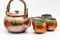 Japanese Tea Set - Red Drip-Glazed Agano-yaki Dobin Teapot and 4 Yunomi Teacups - full set, teapot with arched handle beside teacups, three-quarter view