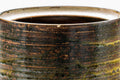 Closeup of the rim and upper body detailing the layered brown and beige glaze.