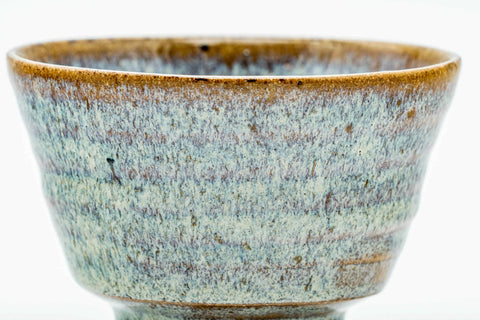 Three-quarter view showing the rim and hare's-fur glaze.