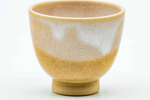 Close-up of a single guinomi, showing the beige-and-white drip glaze.
