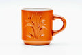 Red shudei Tokoname-yaki handled cup engraved with a bamboo motif, front view with the handle to the right.