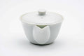 White porcelain handle-less houhin teapot shown closed from the front.