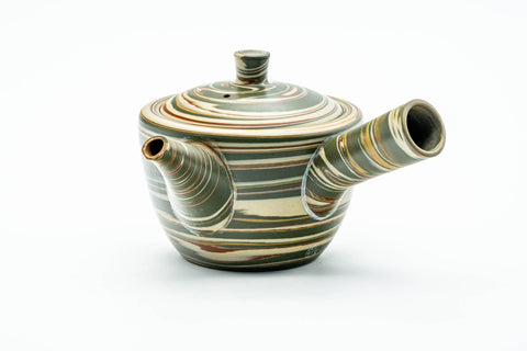 Angled view with the side handle at right and the spout to the lower left.