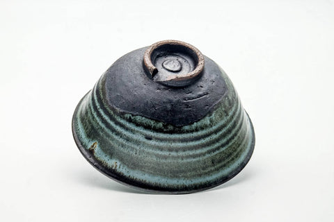 Bowl inverted to show the foot ring and base with glaze running down.