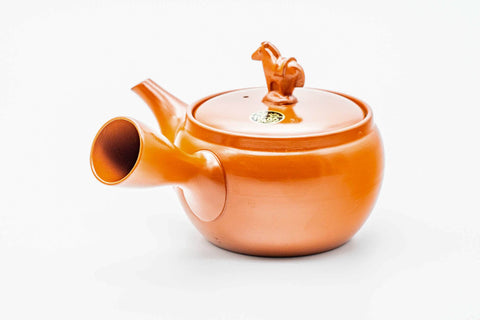 Red shudei Tokoname kyusu, three-quarter view with the spout to the right and handle to the left