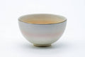 The cup from the reverse, showing a gold rim band over the pale glaze.