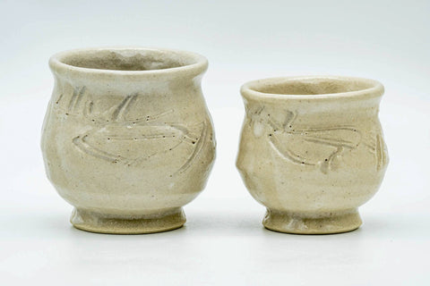 The matched pair — a larger and a smaller cup — standing side by side, front view.