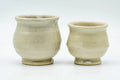 The two beige cups viewed from a slightly different angle.