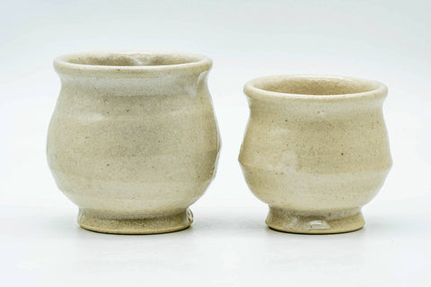 The two beige cups viewed from a slightly different angle.