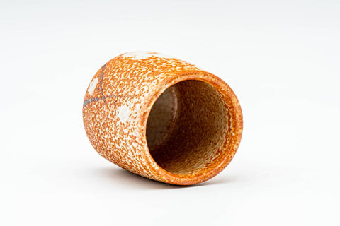 Teacup tilted to show the glazed interior and rim.