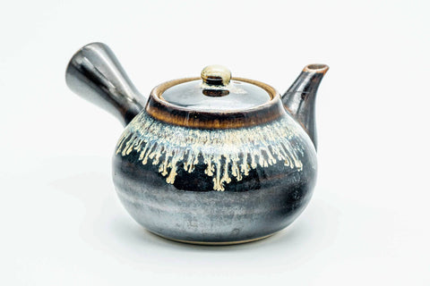 Side view of the drip-glazed kyusu showing the spout, lid on.