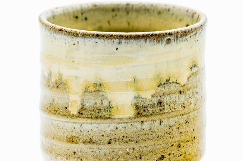 Close-up of the spiraling beige drip glaze on the body.