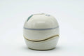 Side view of the closed kogo showing the gold line where lid meets base.
