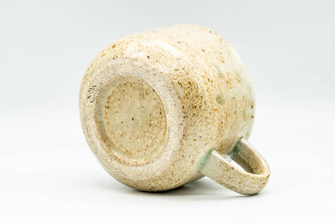Three-quarter view from above and behind, showing the loop handle and the cup's tapered body.