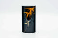 Tall black metal chazutsu tea canister, front view, decorated with an orange leaf branch motif