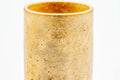Teacup tilted to show the warm cream-orange glazed interior.