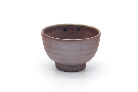 Front view of the yunomi showing the rim and ash-glaze run.