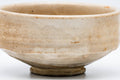 Three-quarter view emphasising the wide low form and milky crazed glaze.