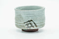 Front view rotated, showing more of the spiralling glaze and grass motif.