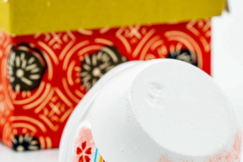 The lid removed and set beside the base, shown against the patterned box.