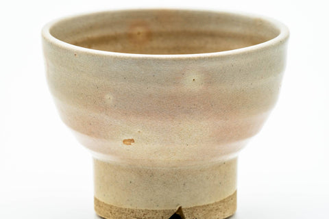 Front view emphasizing the tall foot and the gohonte-spotted beige glaze.
