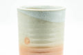 Beige, peach and white glazed Hagi-yaki yunomi teacup - close-up of the upper body and glaze