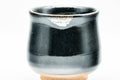 Japanese Teacups - Pair of Jet Black Glazed Yunomi - 130ml - overhead view of both cups, one tilted to show the tan base