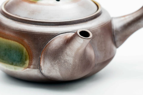 Side view showing the spout and ash-glaze coloring.